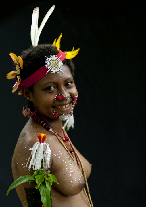 Portrait of a smiling topless tribal woman in traditional clothing, Milne Bay Province, Trobriand Island, Papua New Guinea