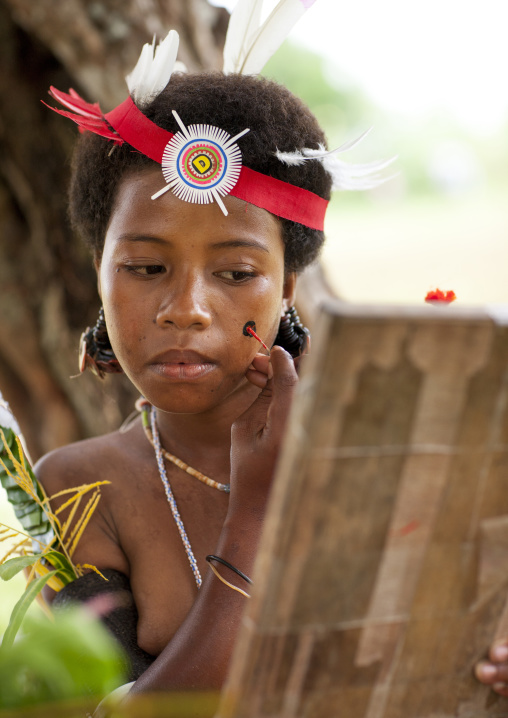 Tribal woman makeup before a ceremony, Milne Bay Province, Trobriand Island, Papua New Guinea