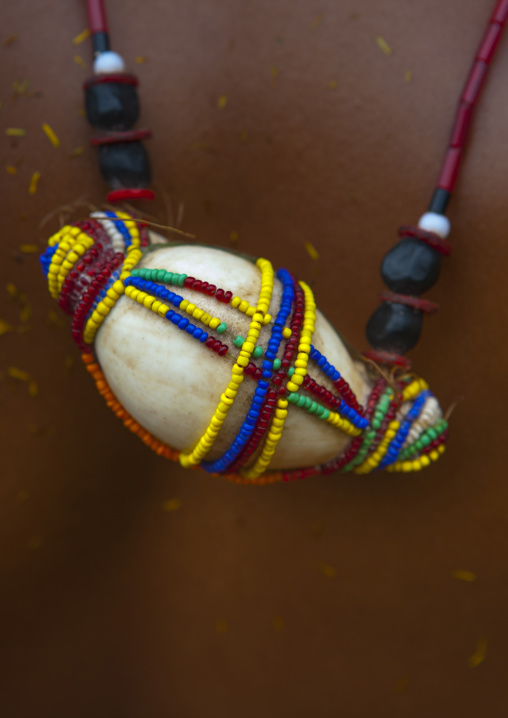 Tribal woman wearing a beaded shell on her back, Milne Bay Province, Trobriand Island, Papua New Guinea