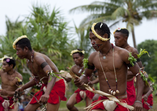 Tribal dancers in traditional clothing during a sing-sing, Milne Bay Province, Trobriand Island, Papua New Guinea