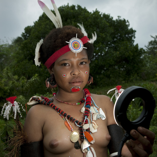 Portrait of a topless tribal woman in traditional clothing, Milne Bay Province, Trobriand Island, Papua New Guinea