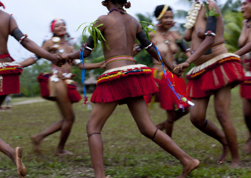 Tribal women dancers with skirts made of banana leaf and pandanus palm leaf, Milne Bay Province, Trobriand Island, Papua New Guinea