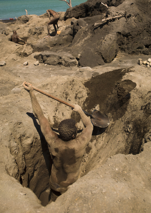 Man digging to find megapode birds eggs in Tavurvur volcano ashes, East New Britain Province, Rabaul, Papua New Guinea