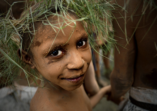 Chimbu tribe boy with a vegetal headwear during a Sing-sing ceremony, Western Highlands Province, Mount Hagen, Papua New Guinea