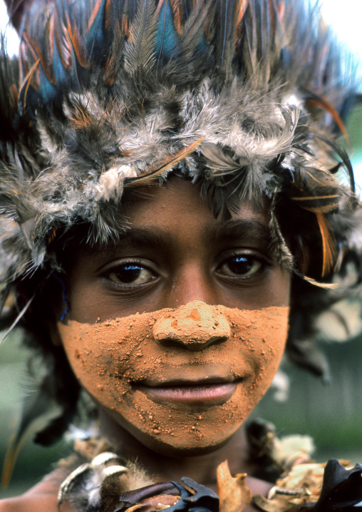 Chimbu tribe boy with a feathers headwear during a Sing-sing ceremony, Western Highlands Province, Mount Hagen, Papua New Guinea