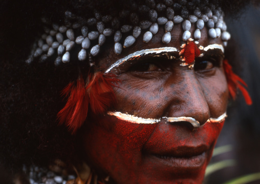 Papuan woman with red tribal makeup on the face, Western Highlands Province, Mount Hagen, Papua New Guinea