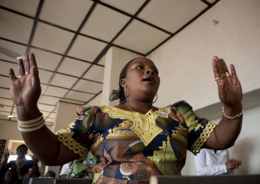 Rwandan woman praying during a sunday mass in a church, Kigali Province, Kigali, Rwanda