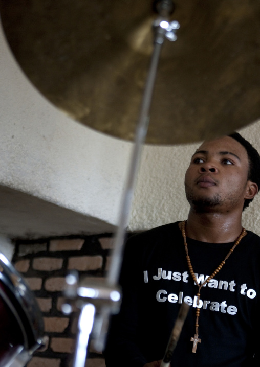 Rwandan man playing drums during a sunday mass in a church, Kigali Province, Kigali, Rwanda