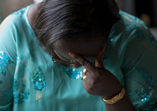 Rwandan woman praying during a sunday mass in a church, Kigali Province, Kigali, Rwanda