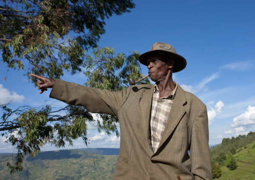 Rwandan old man smoking pipe, Kigali Province, Kigali, Rwanda