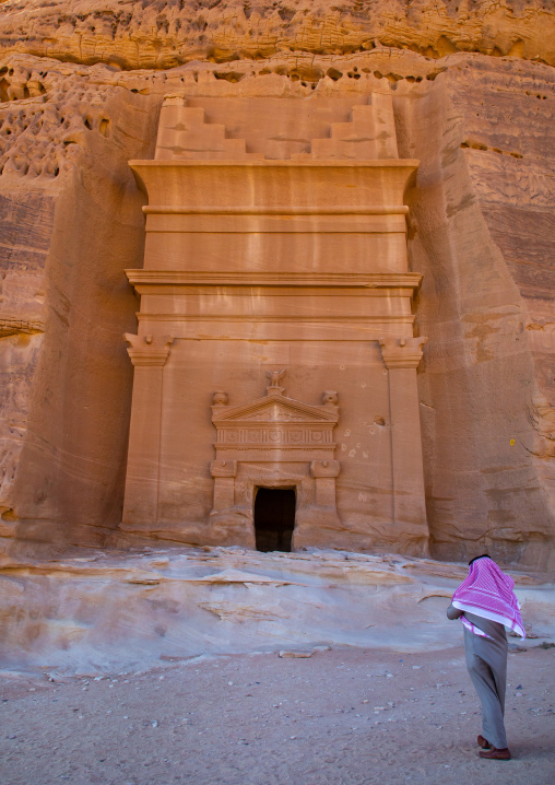 Saudi tourist in front of a tomb in al-Hijr archaeological site in Madain Saleh, Al Madinah Province, Alula, Saudi Arabia