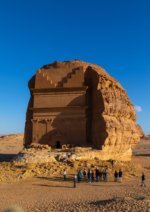 Tourists in front of qasr al-farid tomb of Lihyan son of Kuza in Madain Saleh, Al Madinah Province, Alula, Saudi Arabia