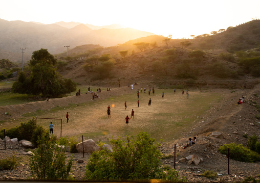 Saudi young men playing football in the sunset, Jizan province, Alaydabi, Saudi Arabia