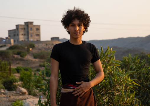 Portrait of a saudi man with curly hair in a mountainous village, Jizan province, Alaydabi, Saudi Arabia