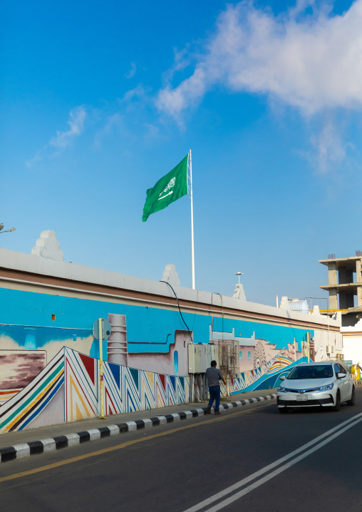 Saudi arabian flag in front of a fresco, Asir province, Abha, Saudi Arabia