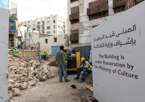 Workers restoring an old house with wooden mashrabiyas in al-Balad quarter, Mecca province, Jeddah, Saudi Arabia