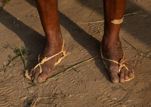 Old saudi man wearing traditional shoes made of palm leaves, Jizan Province, Mahalah, Saudi Arabia