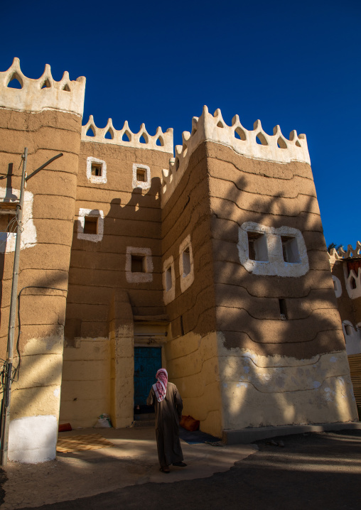 Saudi man entering a traditional mud house, Najran Province, Najran, Saudi Arabia