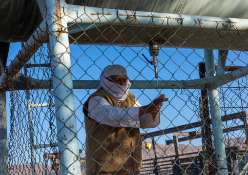 Saudi man washing his hands in the camel market, Najran Province, Najran, Saudi Arabia