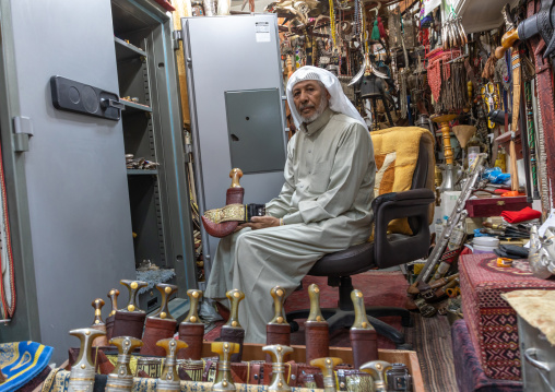 Saudi man holding a janbiya dagger kept in a safe, Najran Province, Najran, Saudi Arabia