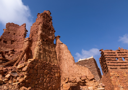 Red stone and mud collpased house in a village, Asir province, Sarat Abidah, Saudi Arabia