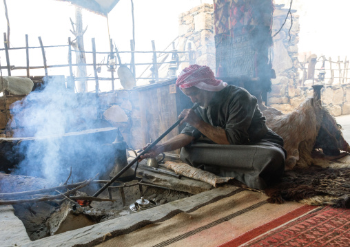 Saudi man blowing on fire in a majlis, Asir province, Tanomah, Saudi Arabia