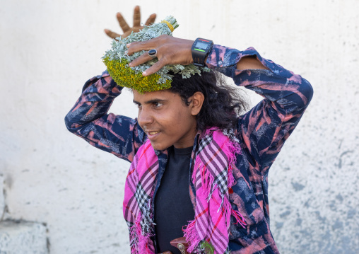 Portrait of a flower man making a floral crown on his head, Jizan Province, Addayer, Saudi Arabia