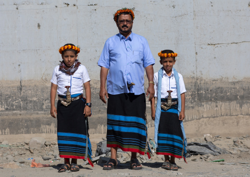 Portrait of a flower man with his sons wearing floral crowns on the heads, Jizan Province, Addayer, Saudi Arabia