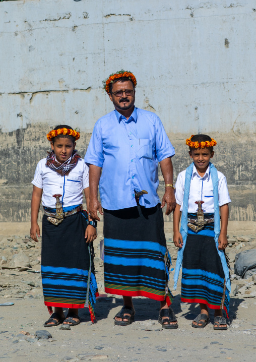 Portrait of a flower man with his sons wearing floral crowns on the heads, Jizan Province, Addayer, Saudi Arabia