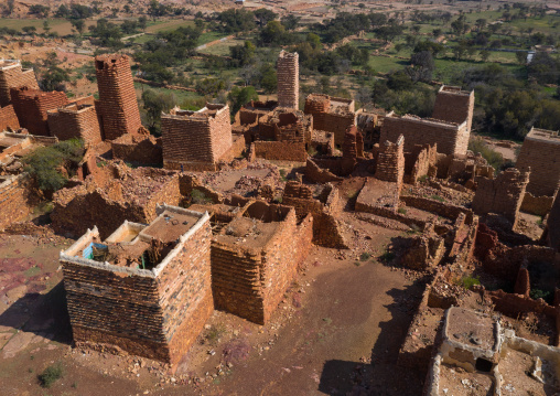 Aerial view of red stone and mud houses with slates in a village, Asir province, Sarat Abidah, Saudi Arabia