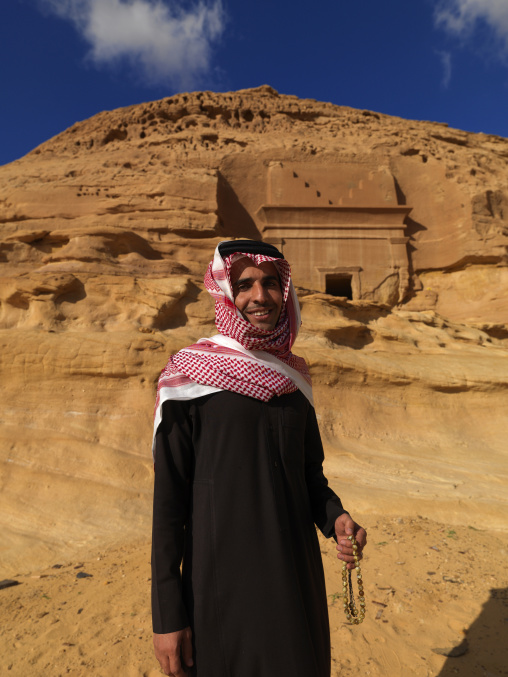 Saudi tourist in front of a Nabataean tomb in al-Hijr archaeological site in Madain Saleh, Al Madinah Province, Alula, Saudi Arabia