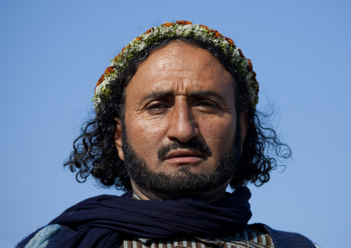 Portrait of a flower man wearing a floral crown on the head, Jizan province, Addayer, Saudi Arabia