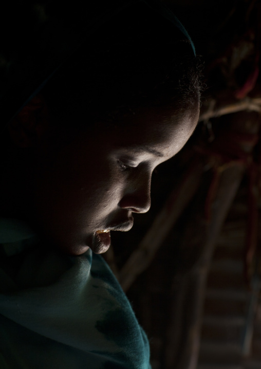 Profile Portrait Of A Serious Head Bended Teenage Girl In  Low Light, Hargeisa, Somaliland