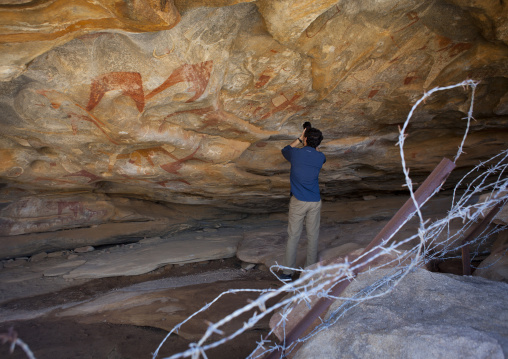 Backside Of A Westerner Taking Pictures With A Camera Inside The Laas Geel Caves, Hargeisa, Somaliland