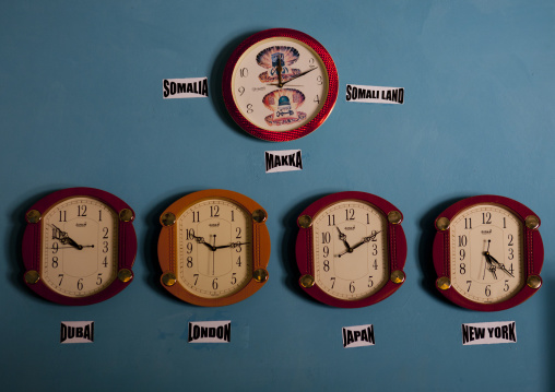 Five Clocks Indicating The Time In Other Capital Cities In The World Hanging On A Blue Wall, Burao, Somaliland