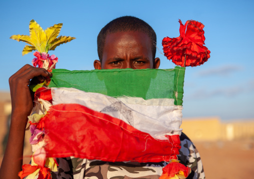 Portrait of a teenage boy with a national flag, Togdheer region, Burao, Somaliland