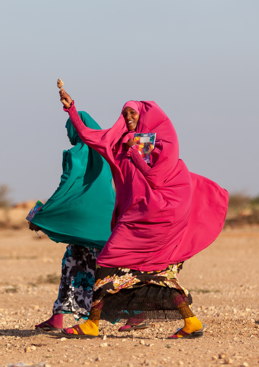 Somali teenage girl eating an ice cream in the street, Woqooyi Galbeed province, Baligubadle, Somaliland