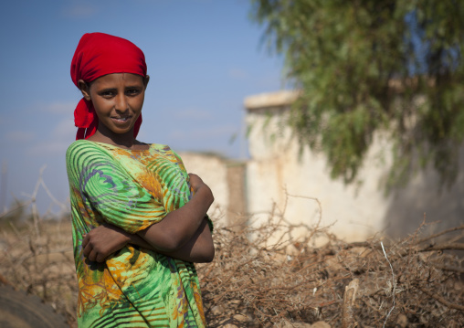 A Smiling Young Woman Wearing A Red Scarf And Standing Outside, Baligubadle, Somaliland