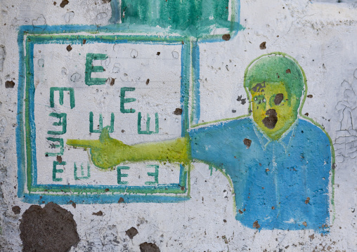 An Optician Advertisement Painted Billboard Depicting An Optician Giving An Eye Test, Boorama, Somaliland