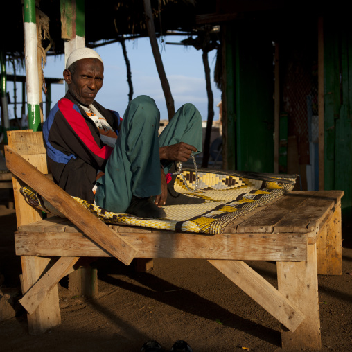 Mature Man Sat Outdoors On Wooden Couch, Zeila, Somaliland