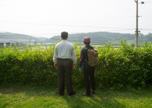 South korean couple in front of freedom and railway bridge over imjin river between north and south korea, Sudogwon, Paju, South korea