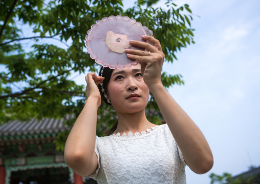 South korean woman called juyeon looking at herself in a mirror, Sudogwon, Paju, South korea