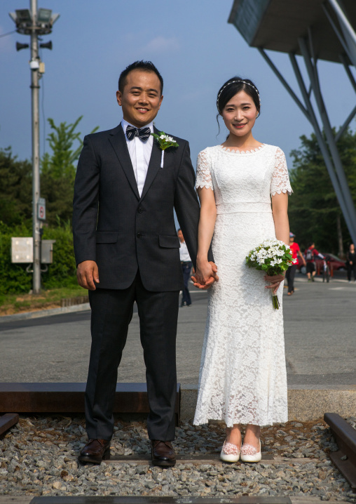 North korean defector joseph park taking a picture of his south korean fiancee juyeon on the north and south korea border, Sudogwon, Paju, South korea