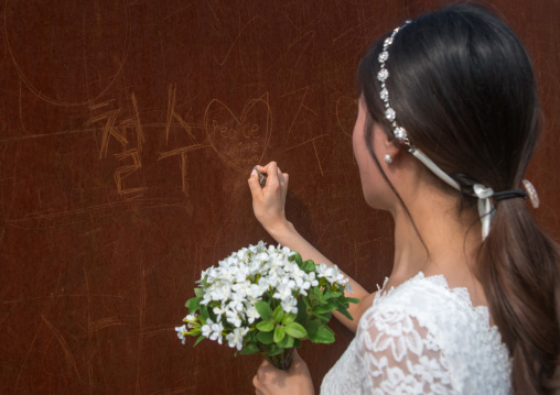 South korean woman called juyeon writing a peace message on the north and south korea border, Sudogwon, Paju, South korea