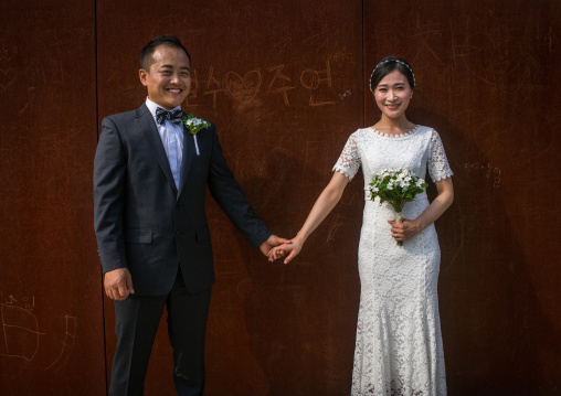 North korean defector joseph park taking a picture of his south korean fiancee juyeon on the north and south korea border, Sudogwon, Paju, South korea