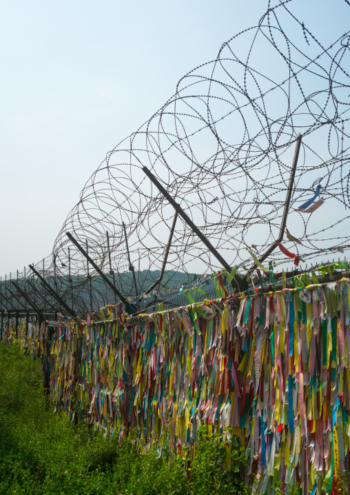 Messages of peace and unity written on ribbons left on fence at dmz, Sudogwon, Paju, South korea