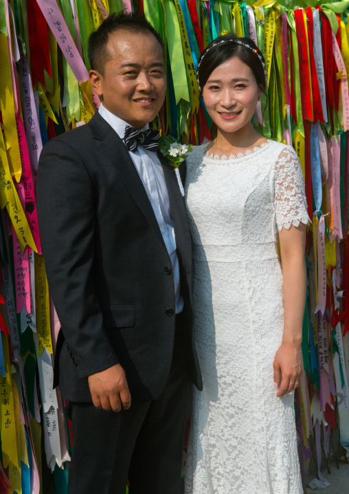 North korean defector joseph park with his south korean fiancee juyeon in front of messages of peace written on ribbons left on dmz, Sudogwon, Paju, South korea