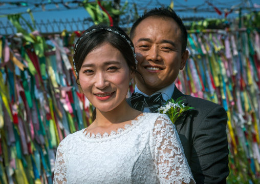 North korean defector joseph park with his south korean fiancee juyeon in front of messages of peace written on ribbons left on dmz, Sudogwon, Paju, South korea