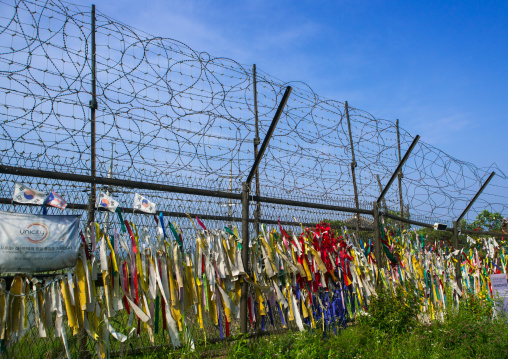 Messages of peace and unity written on ribbons left on fence at dmz, Sudogwon, Paju, South korea