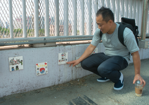 North korean defector joseph park discovering drawings made by north korean children in yangcheong 
, National capital area, Seoul, South korea